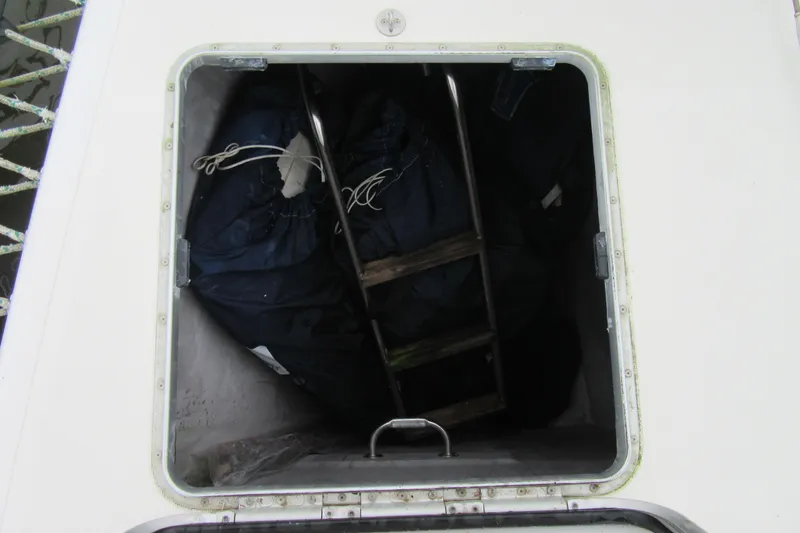 Slide: The Image of Storage compartment on a 2001 Catana 471 sailboat, containing a ladder and equipment. - 46
