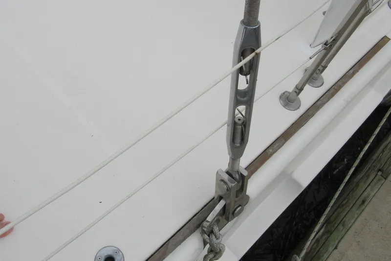 Slide: The Image of Close-up of Catana 471 sailboat rigging, showcasing deck fittings and tensioning hardware, 2001 model. - 51