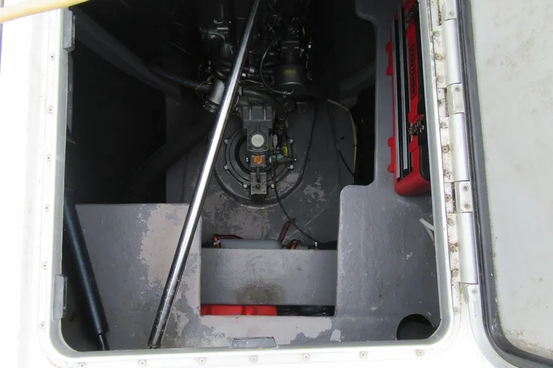 Slide: The Image of Engine compartment of a 2001 Catana 471 sailboat, showing mechanical components and storage. - 60