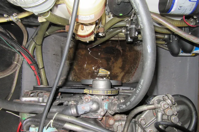 Slide: The Image of Engine compartment of a 2001 Catana 471 with visible hoses and wiring. - 65
