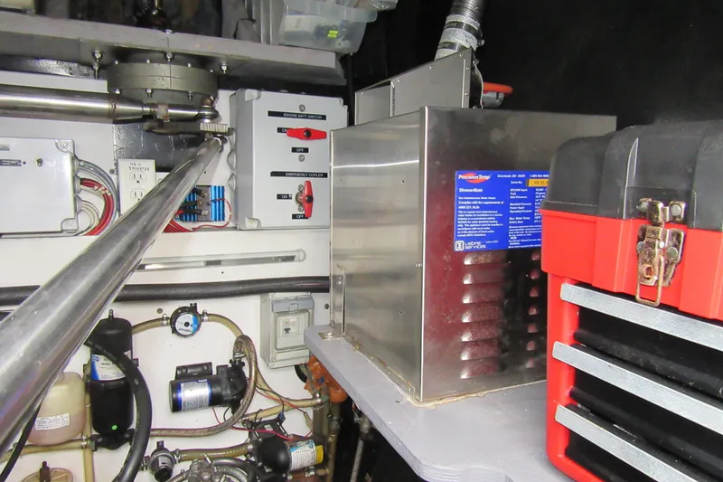 Slide: The Image of Engine room of 2001 Catana 471 yacht with mechanical components and toolbox. - 68