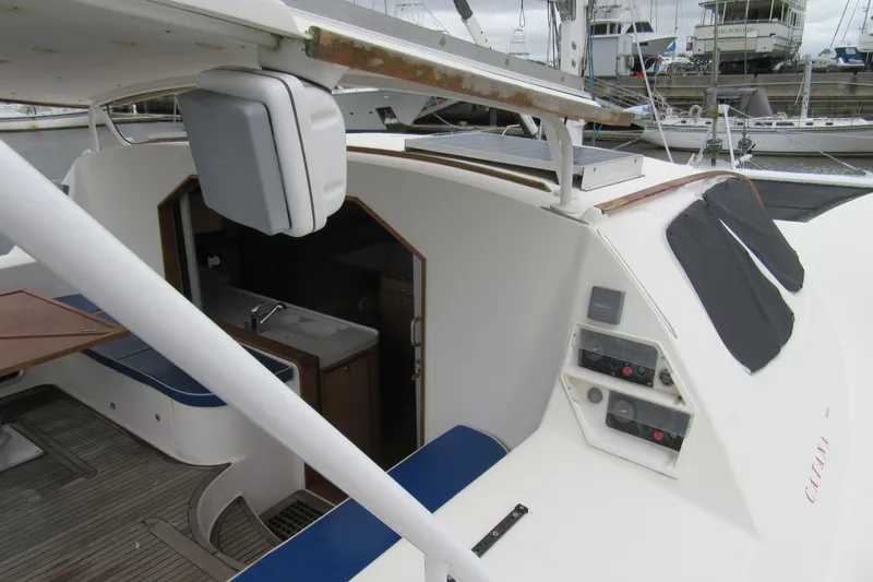 Slide: The Image of 2001 Catana 471 yacht cockpit with seating, control panels, and interior view at marina. - 7