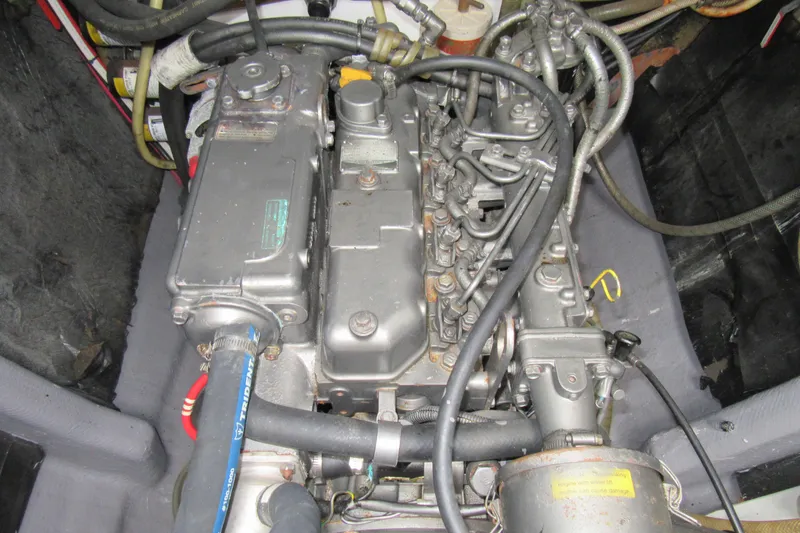 Slide: The Image of Engine compartment of a 2001 Catana 471 yacht, showcasing mechanical components and wiring. - 75