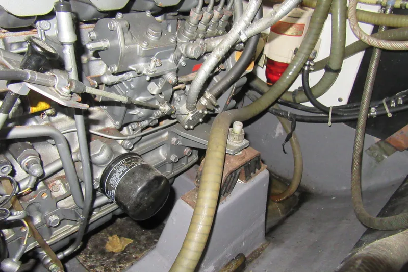 Slide: The Image of Engine compartment of a 2001 Catana 471 sailboat, showing hoses and mechanical components. - 76