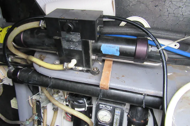 Slide: The Image of Engine compartment of a 2001 Catana 471 with various hoses and components. - 81