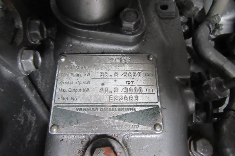 Slide: The Image of Yanmar diesel engine plate on a 2001 Catana 471, showing specifications and model details. - 84