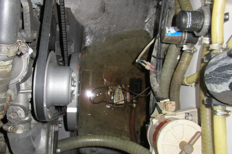 Slide: The Image of Engine compartment of a 2001 Catana 471 with visible belts and hoses. - 87