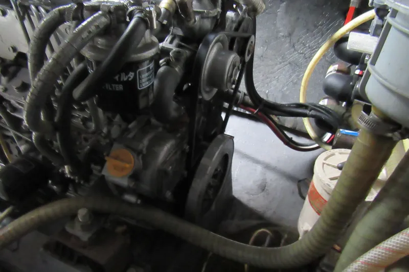 Slide: The Image of Engine compartment of a 2001 Catana 471 sailboat, showing hoses and components. - 88