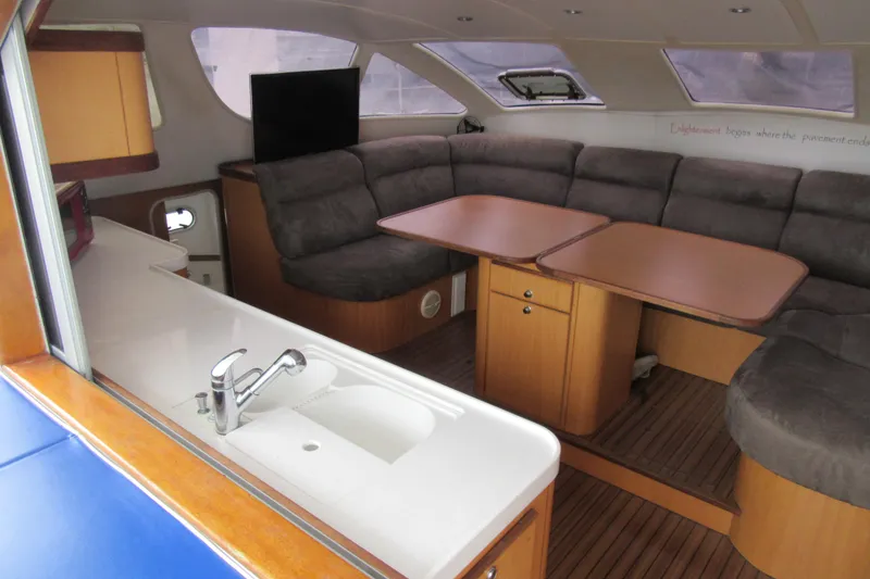 Slide: The Image of Interior of 2001 Catana 471 yacht with cozy seating and modern kitchen area. - 90