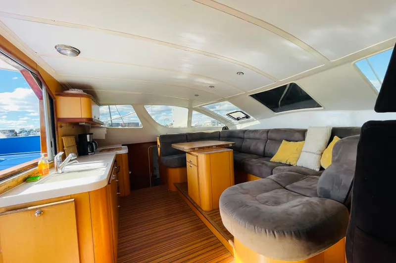 Slide: The Image of Interior of 2001 Catana 471 yacht with cozy seating and kitchenette. - 92