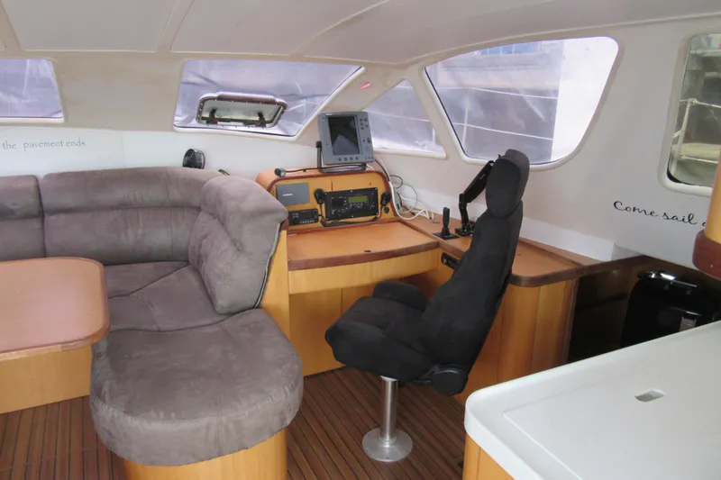 Slide: The Image of Interior of a 2001 Catana 471 yacht with plush seating and navigation equipment. - 93