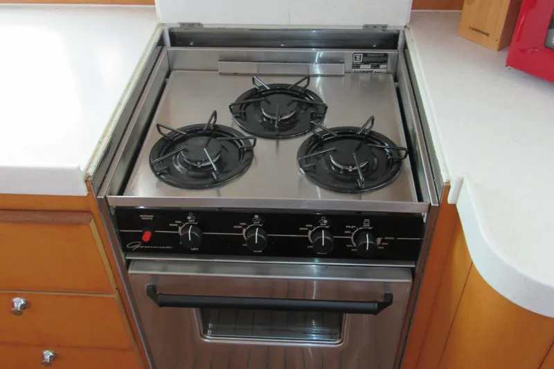 Slide: The Image of Three-burner stove in a 2001 Catana 471 yacht kitchen, featuring stainless steel design. - 99