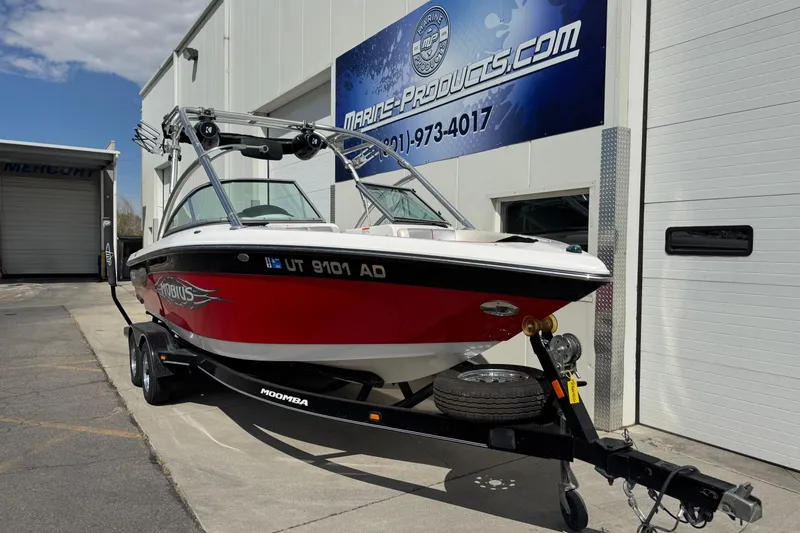 Slide: The Image of 2006 Moomba Mobius XLV boat on trailer outside Marine Products store. - 3