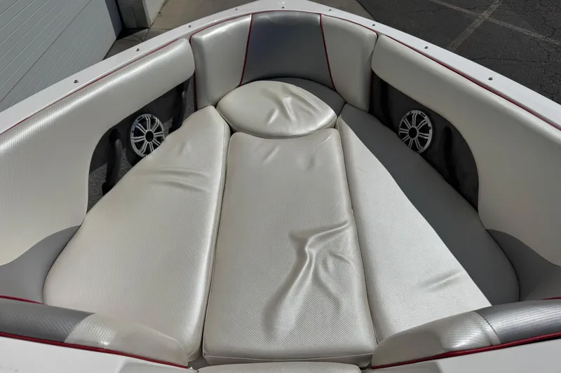 Slide: The Image of 2006 Moomba Mobius XLV boat interior with white cushioned seating and built-in speakers. - 5
