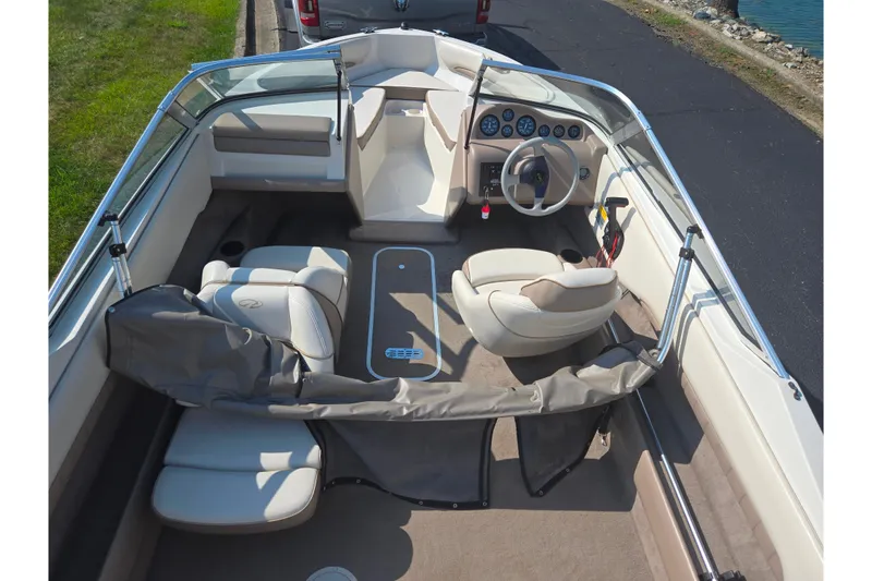 Slide: The Image of 1998 Regal Valanti 176 boat interior with beige seating and steering wheel. - 10