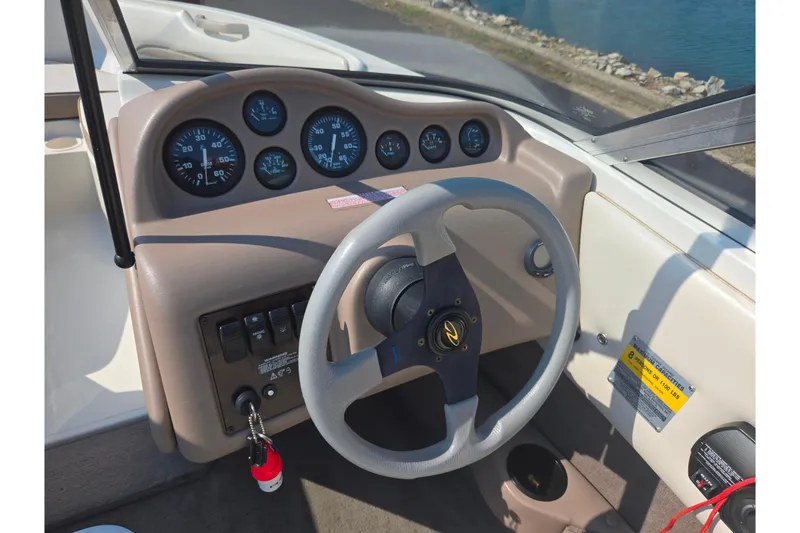 Slide: The Image of 1998 Regal Valanti 176 boat dashboard with steering wheel and instrument panel. - 13