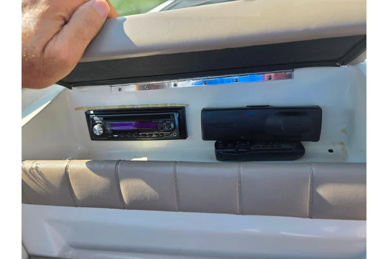 Slide: The Image of 1998 Regal Valanti 176 dashboard with stereo system and hand resting on seat. - 15