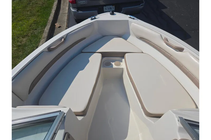 Slide: The Image of 1998 Regal Valanti 176 boat interior with beige seating and cup holders. - 16