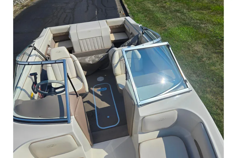 Slide: The Image of 1998 Regal Valanti 176 boat interior with beige seating and open windshield. - 18