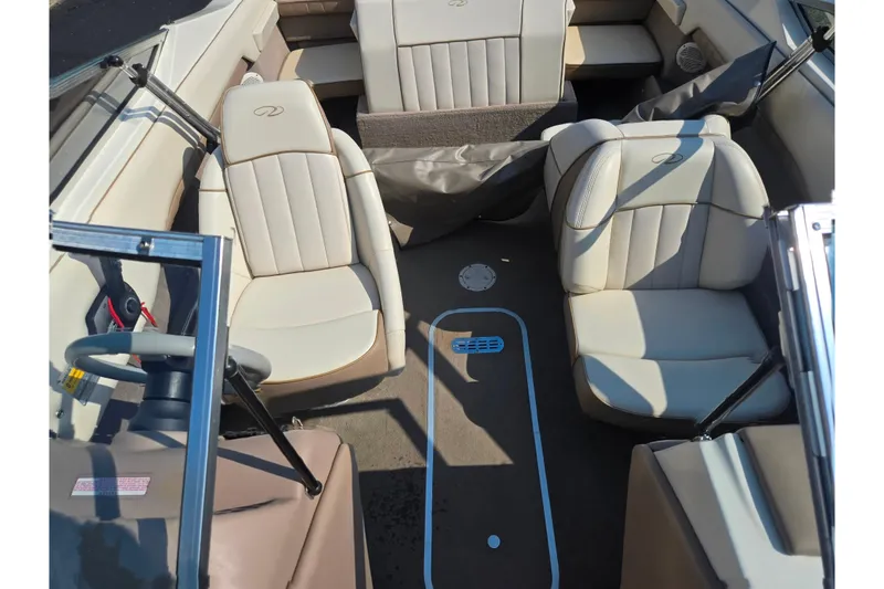 Slide: The Image of Interior of a 1998 Regal Valanti 176 boat with beige seating and steering wheel. - 19