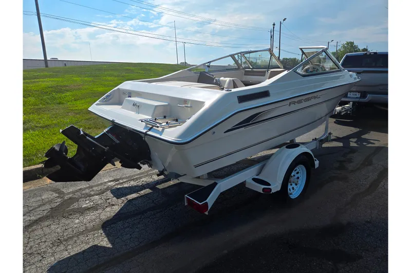 Slide: The Image of 1998 Regal Valanti 176 boat on trailer, parked outdoors on a sunny day. - 3