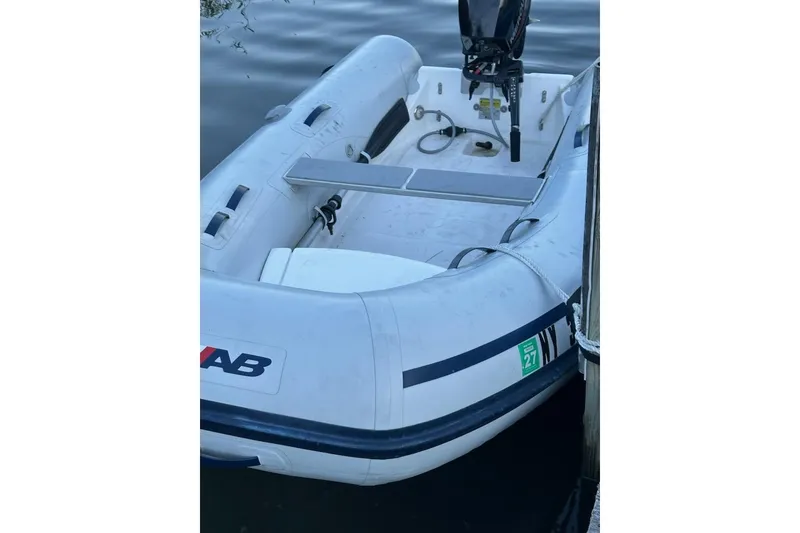 Slide: The Image of 2023 AB Inflatables Navigo 9 VS boat docked on calm water. - 2