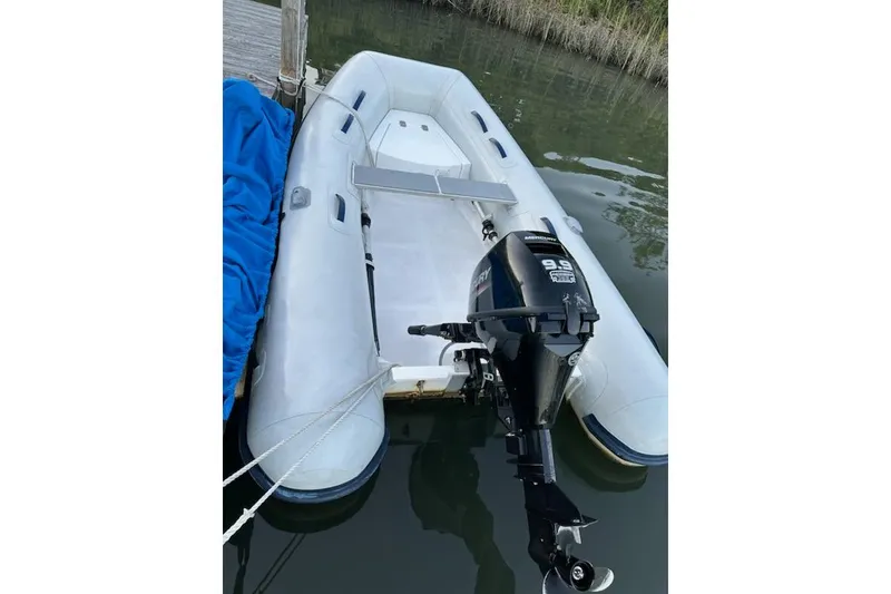 Slide: The Image of 2023 AB Inflatables Navigo 9 VS boat with outboard motor docked on calm water. - 3