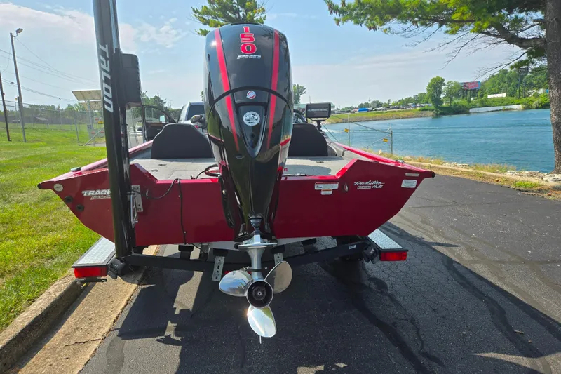 Slide: The Image of 2020 Tracker Pro Team 195 TXW Tournament Edition boat by a lakeside road. - 2