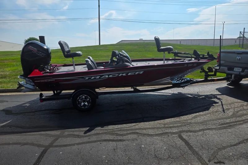 Slide: The Image of 2020 Tracker Pro Team 195 TXW Tournament Edition boat on trailer, parked outdoors. - 4