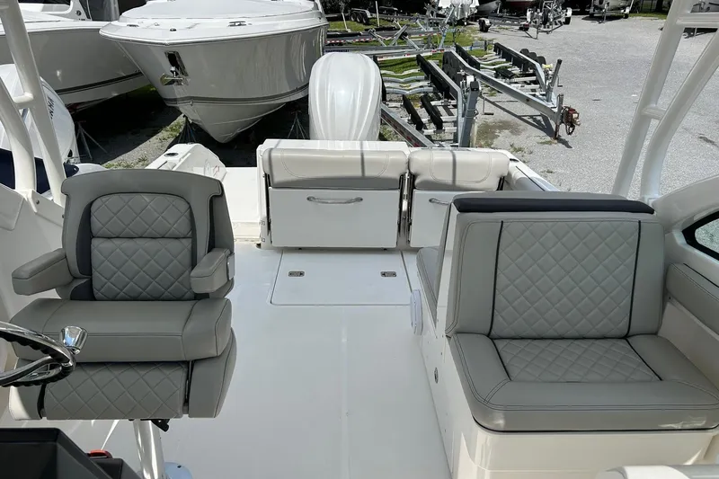 Slide: The Image of 2023 Pursuit DC 246 Dual Console boat interior with luxurious seating and sleek design. - 2