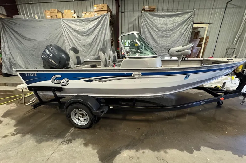 Slide: The Image of 2011 G3 Angler V172 FS fishing boat on trailer in a garage setting. - 3