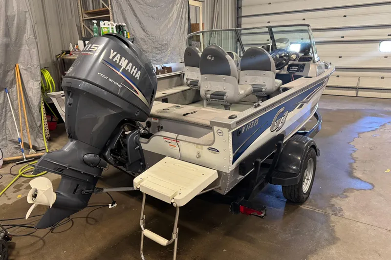 Slide: The Image of 2011 G3 Angler V172 FS boat with Yamaha 115 outboard motor in a garage. - 4