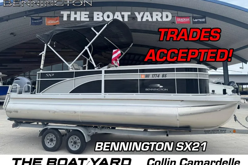 The Image of 2021 Bennington SX21 pontoon boat at dealership, trades accepted, displayed on trailer. - 1
