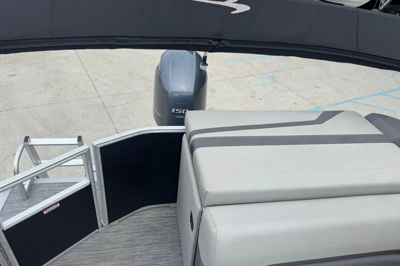 Slide: The Image of 2021 Bennington SX21 boat interior with Yamaha 150 engine, featuring seating and entry gate. - 12