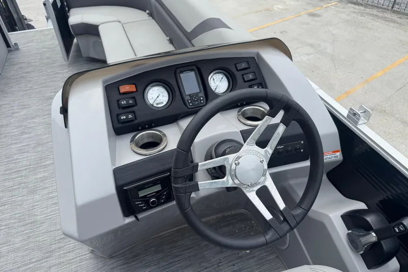 Slide: The Image of 2021 Bennington SX21 boat dashboard with steering wheel and control panel. - 16