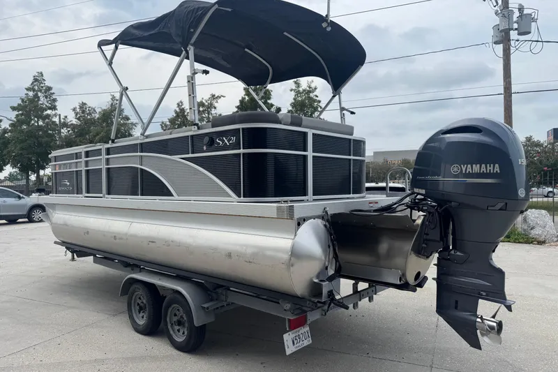 Slide: The Image of 2021 Bennington SX21 pontoon boat with Yamaha outboard motor on trailer. - 5
