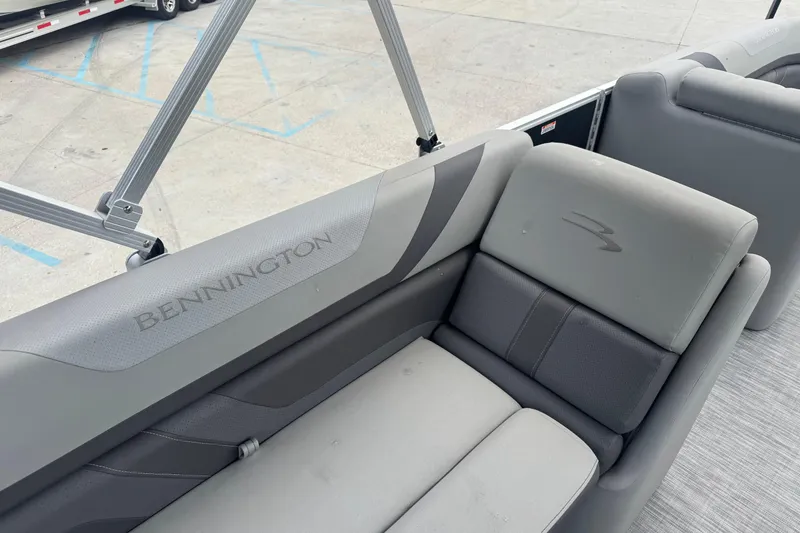 Slide: The Image of 2021 Bennington SX21 boat interior with gray seating and logo detail. - 8