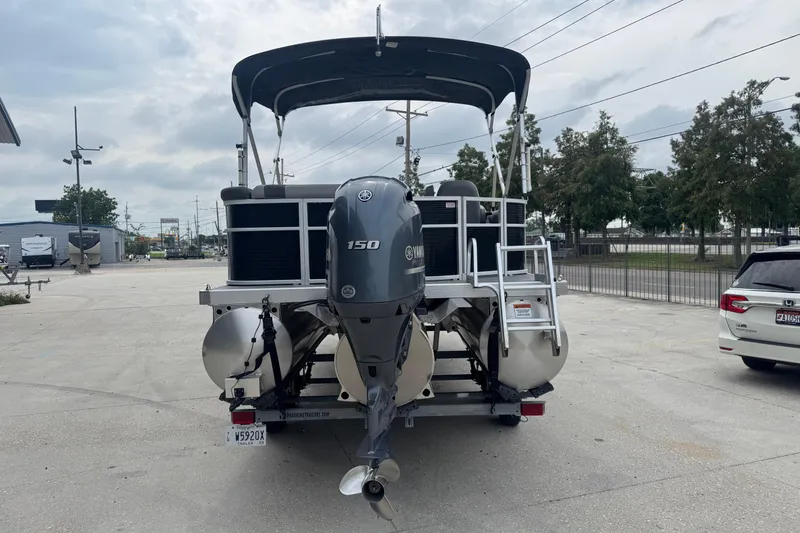 Slide: The Image of 2021 Bennington SX21 pontoon boat with Yamaha 150 engine, parked outdoors. - 9