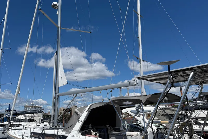 Slide: The Image of 2013 Beneteau Oceanis 41 sailboat docked under a clear blue sky. - 10