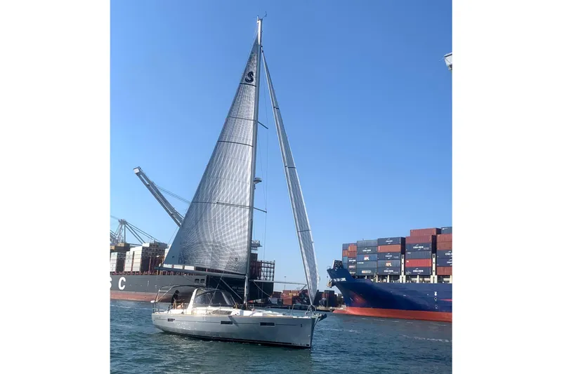Slide: The Image of Sailing yacht Beneteau Oceanis 41, 2013 model, cruising near container ships in a busy port. - 105