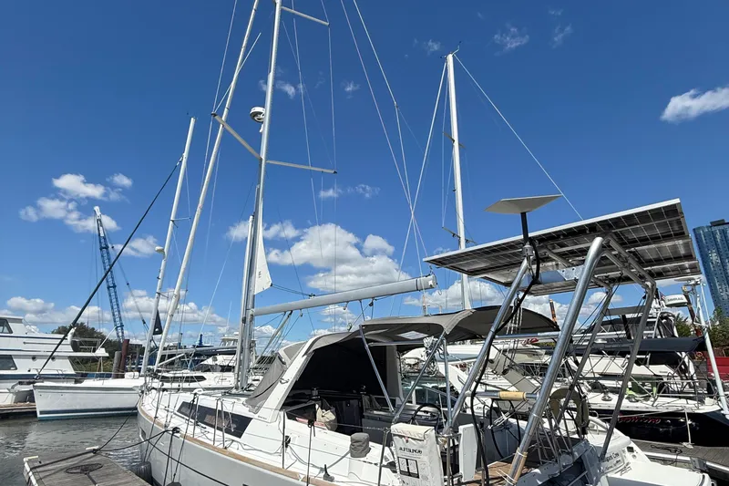 Slide: The Image of 2013 Beneteau Oceanis 41 sailboat docked under a clear blue sky. - 11