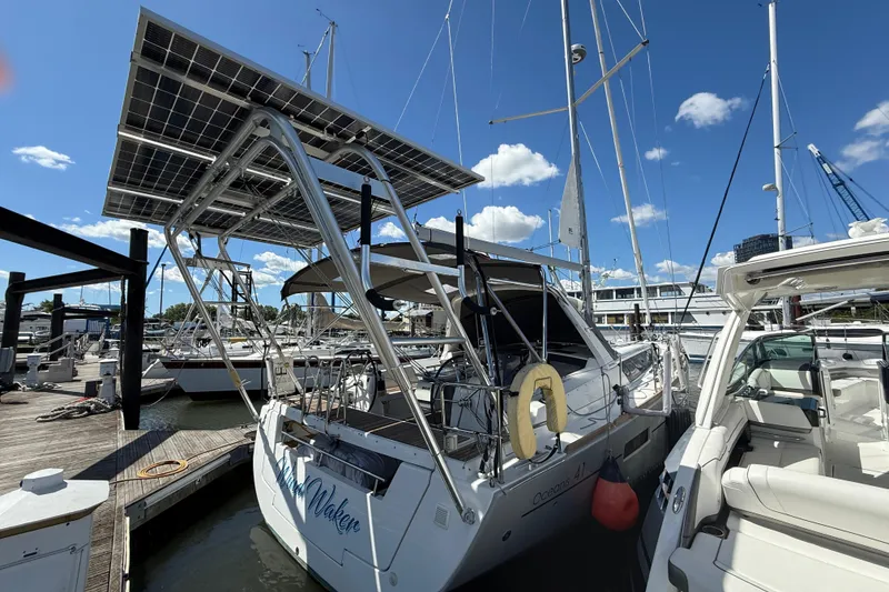 Slide: The Image of 2013 Beneteau Oceanis 41 sailboat with solar panels docked at marina. - 13