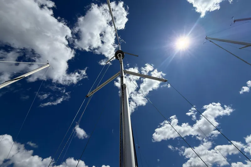 Slide: The Image of Sailboat mast of 2013 Beneteau Oceanis 41 against a sunny, cloudy sky. - 16