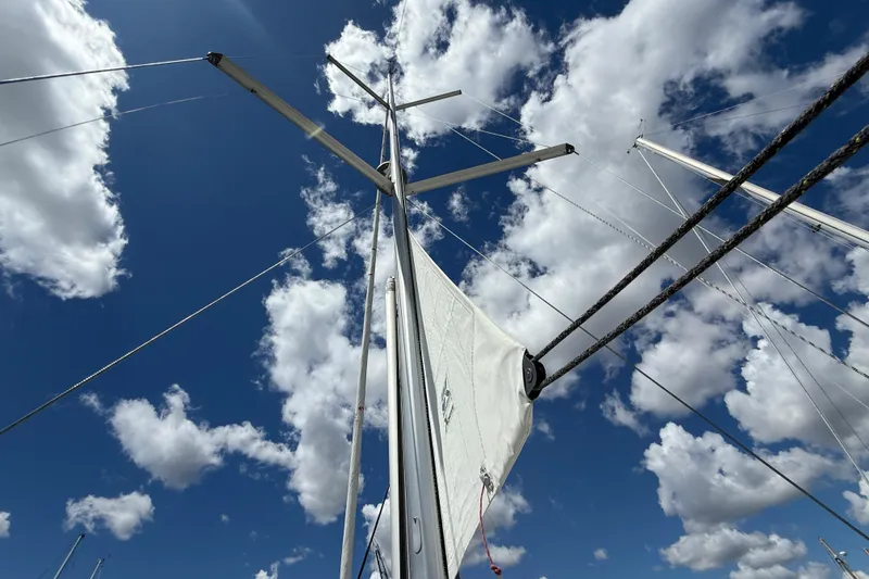 Slide: The Image of Sailboat mast and rigging of 2013 Beneteau Oceanis 41 against a cloudy blue sky. - 17