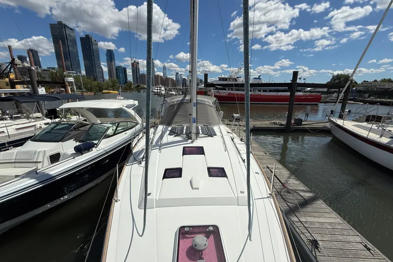 Slide: The Image of 2013 Beneteau Oceanis 41 sailboat docked in urban marina with city skyline. - 23