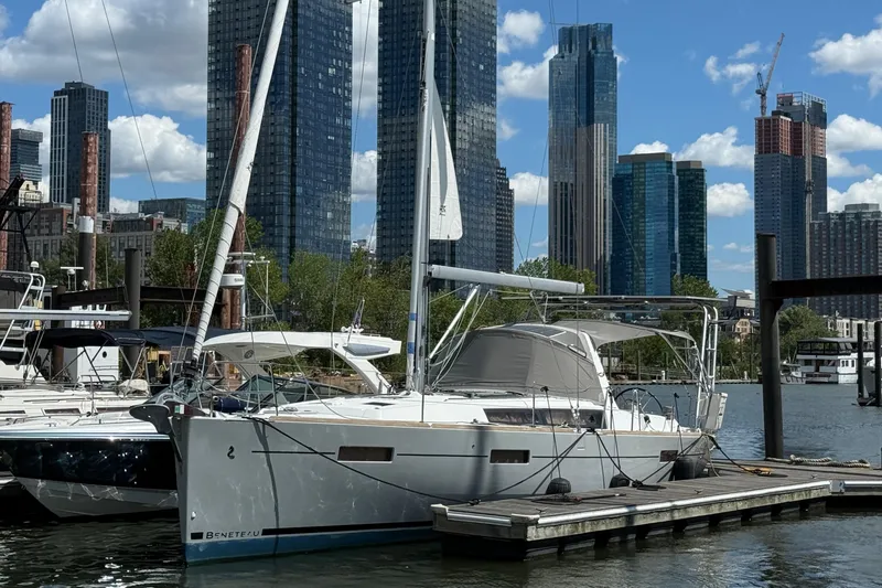 The Image of 2013 Beneteau Oceanis 41 sailboat docked in urban marina with skyscrapers in background. - 3