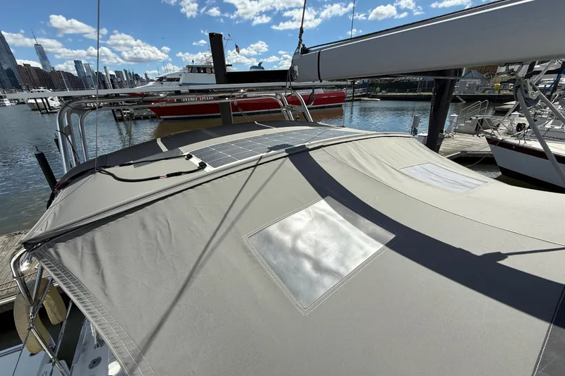 Slide: The Image of 2013 Beneteau Oceanis 41 sailboat with solar panels docked in a marina. - 30