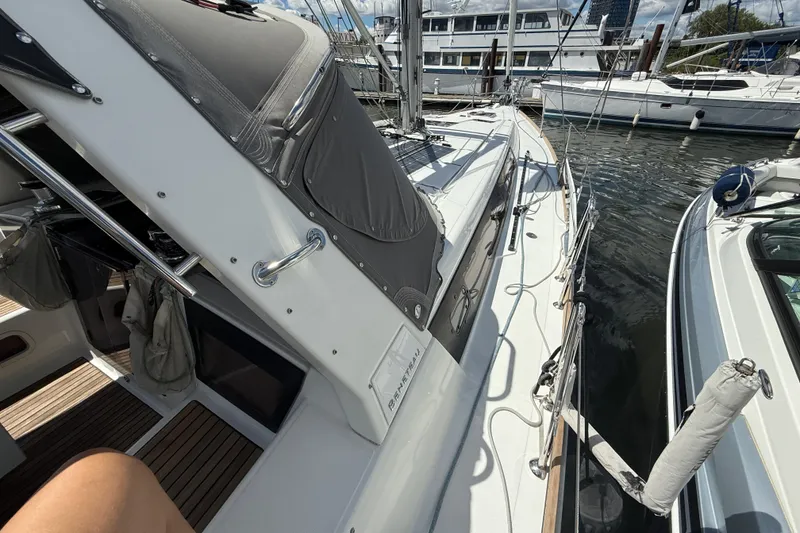 Slide: The Image of 2013 Beneteau Oceanis 41 sailboat docked at marina, showcasing deck and rigging. - 32