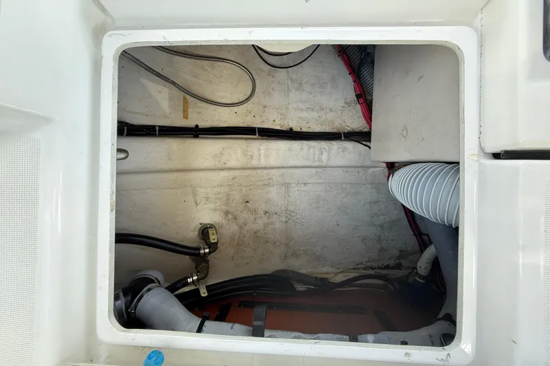 Slide: The Image of Storage compartment of a 2013 Beneteau Oceanis 41 sailboat, showing cables and hoses. - 38