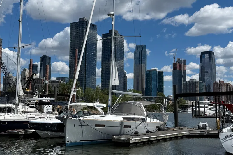Slide: The Image of Beneteau Oceanis 41 sailboat docked in a marina with city skyline, 2013 model. - 4